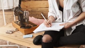 when-hobby-become-real-work-cropped-shot-creative-female-designer-clothes-sitting-table-near-sewing-machine-her-workshop-making-notes-planning-new-design-her-clothing-line_176420-14572-1 (1)